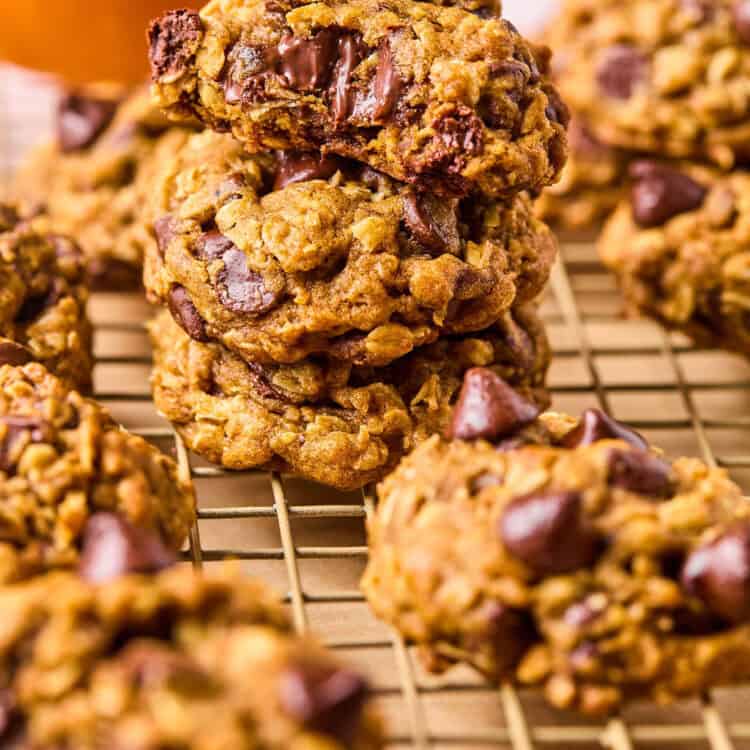 Brown Butter Pumpkin Oatmeal Cookies stacked vertically on a cooling rack.