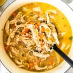 Lemon Chicken Barley Soup in a pot with a ladle.