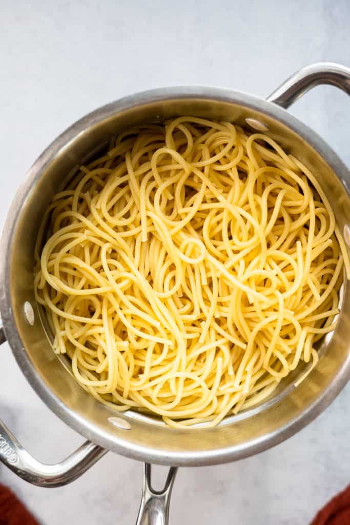 Cooked spaghetti noodles in a pot.