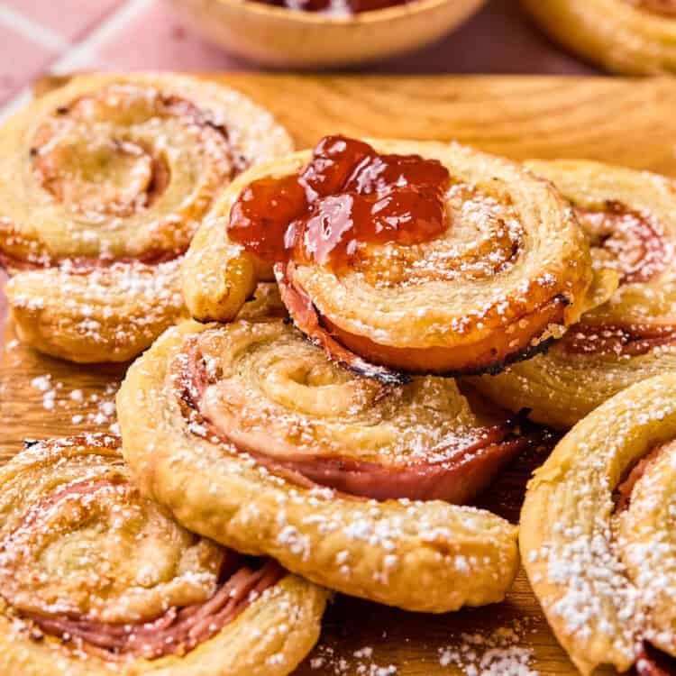 Monte Cristo Pinwheels on a cutting board with a side of jam.