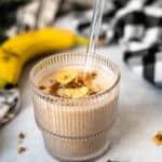 Banana Bread Smoothie in a short glass with a straw.