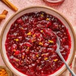 Healthy Cranberry Sauce in a bowl with a spoon.