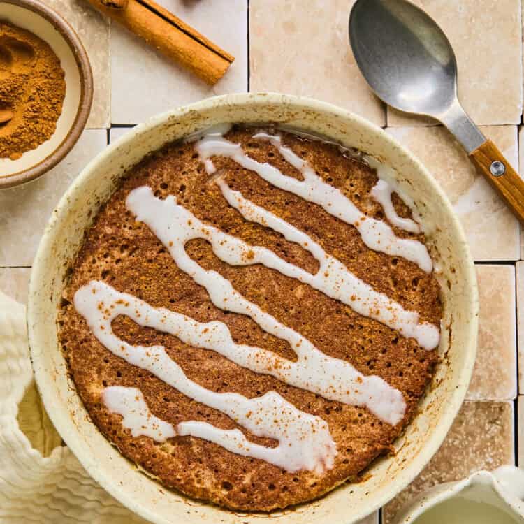 Cinnamon Roll Pancake Bowl topped with glaze in a bowl.