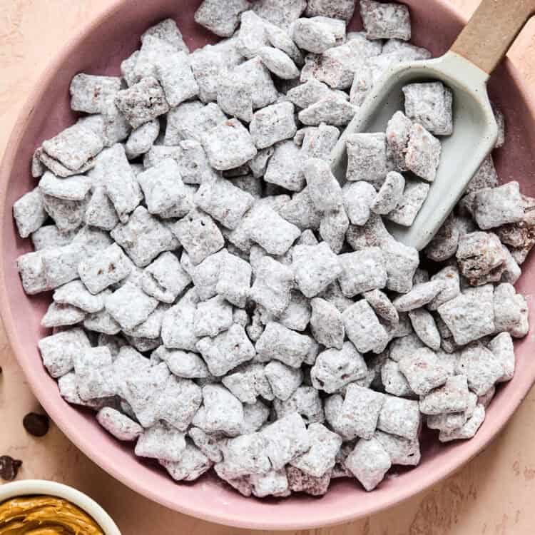 Muddy Buddies in a bowl with a scoop.