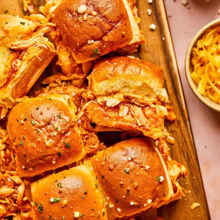 Chicken Enchilada Sliders on a baking sheet with parchment paper.