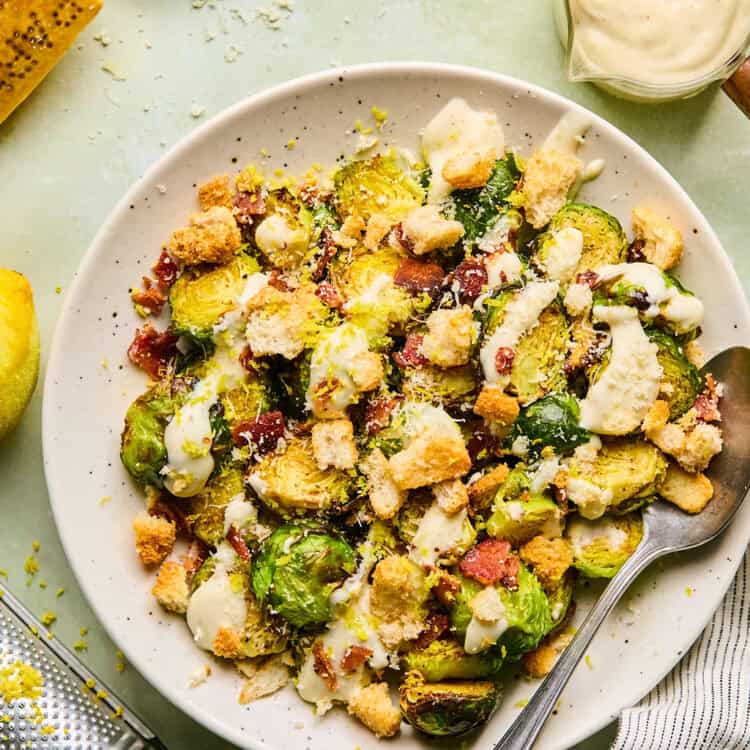 Caesar brussels sprouts on a plate with a fork.