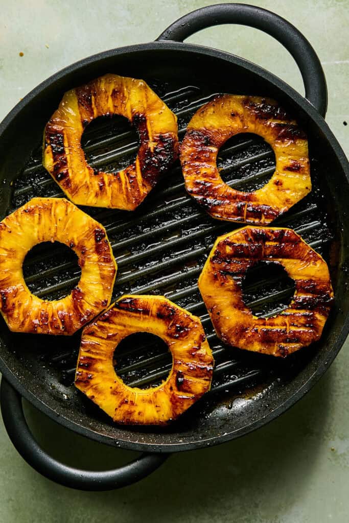 Pineapple rings on a grill pan.