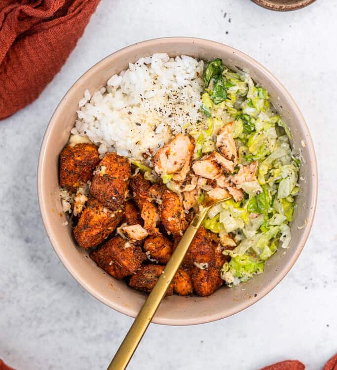 Blackened Salmon Caesar Bowl with a fork.