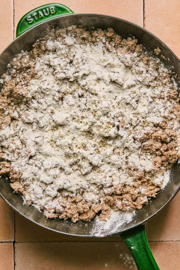 Flour and sage sprinkled on lot of cooked turkey sausage.