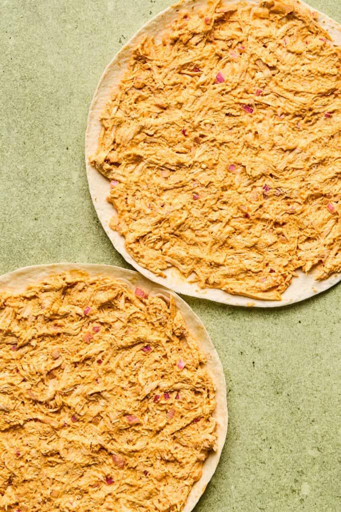 Tortillas topped with buffalo chicken.