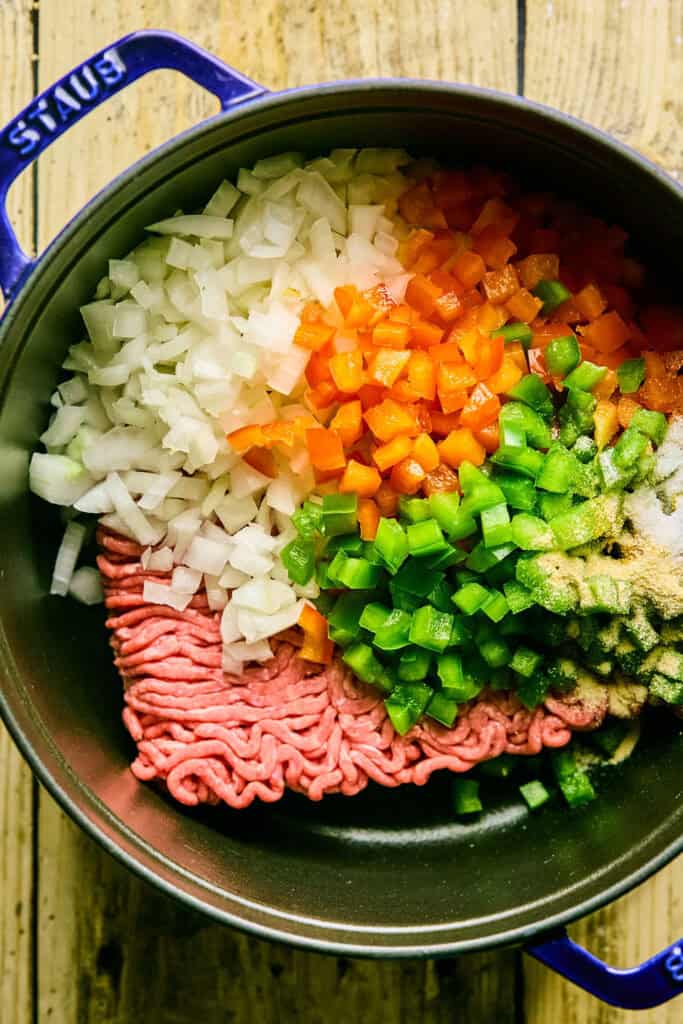 Ground beef and chop veggies in a pot.