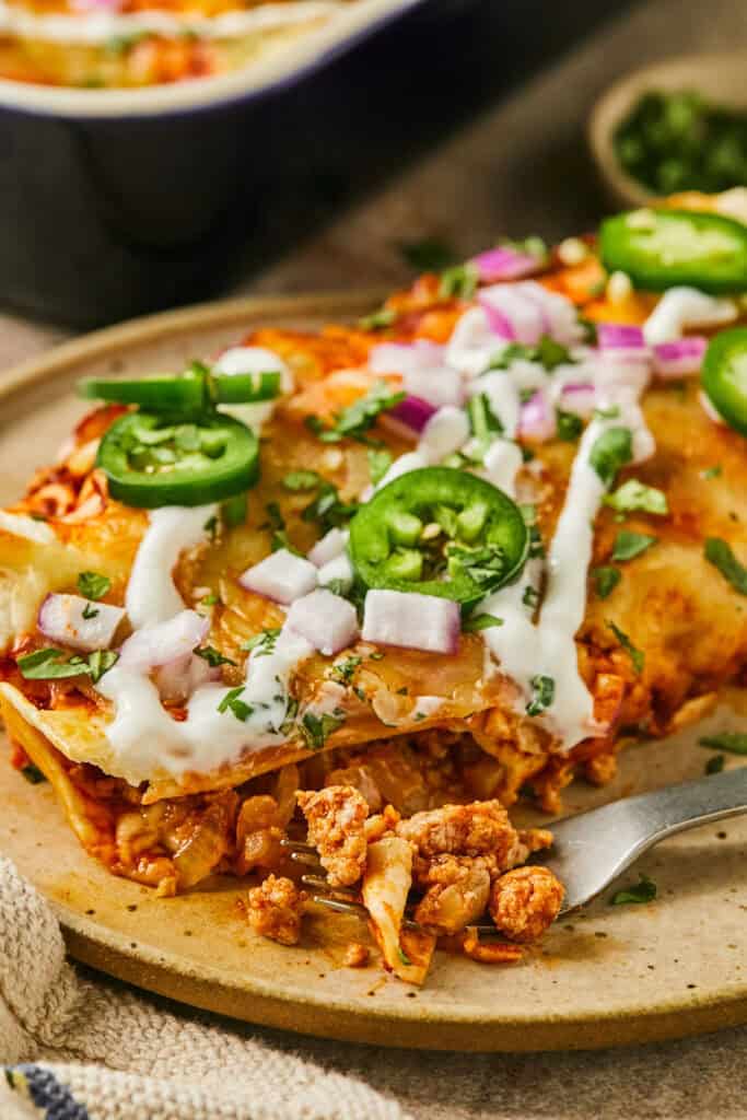 Ground Turkey Enchiladas on a plate with a fork.