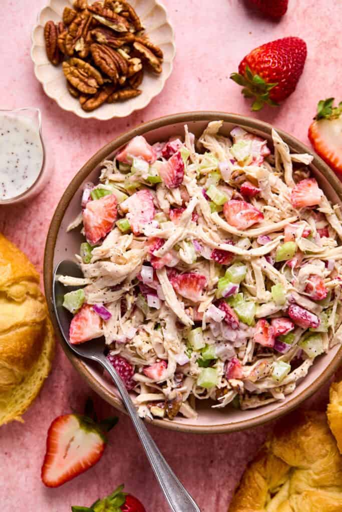 Strawberry Poppyseed Chicken Salad in a bowl witwh a fork.