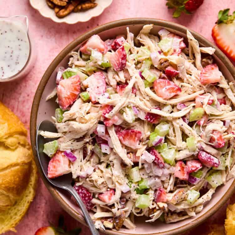 Strawberry Poppyseed Chicken Salad in a bowl witwh a fork.