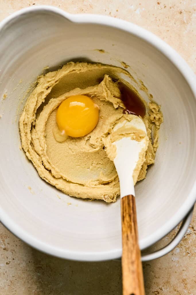 Egg yolk and vanilla added to the mixing bowl.
