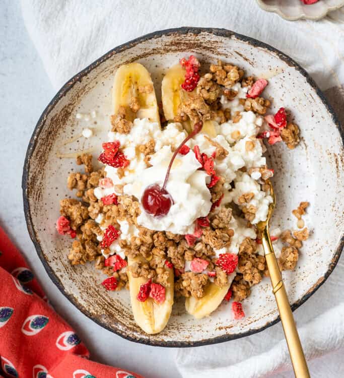 Cottage Cheese Banana Split in a bowl with a spoon.