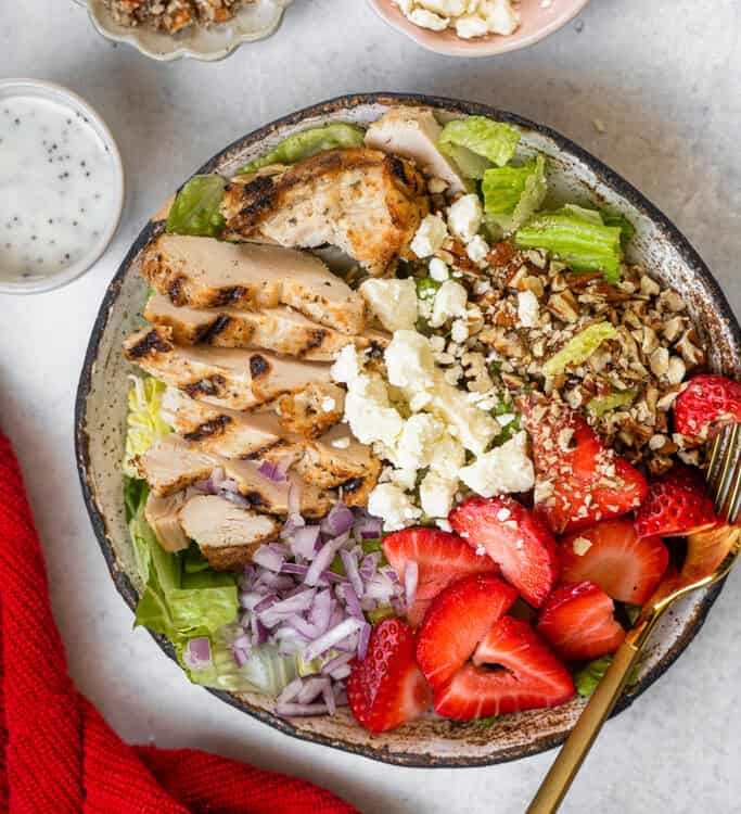 Strawberry Grilled Chicken Salad in a bowl with a fork.