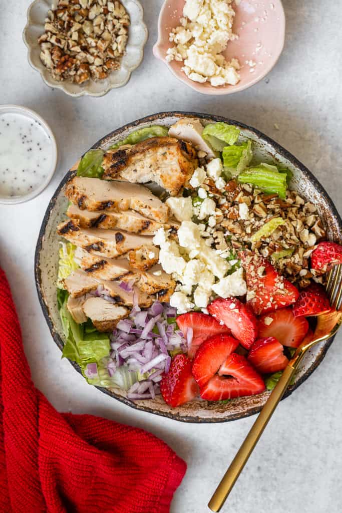 Strawberry Grilled Chicken Salad in a bowl with a fork.