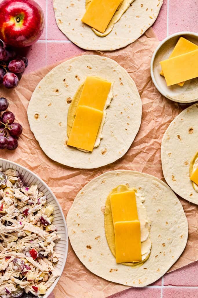 Torillas topped with mayo, mustard, and cheese.