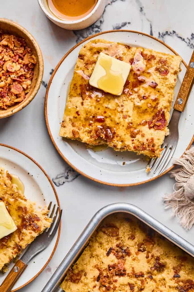 Maple Bacon Pancake Bake on a plate topped with butter and syrup.