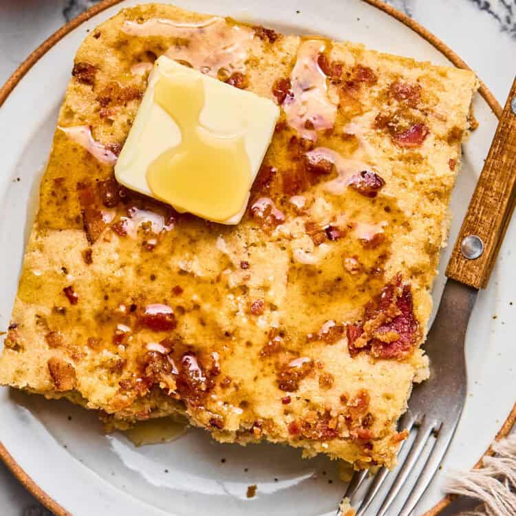 Maple Bacon Pancake Bake on a plate topped with butter and syrup.