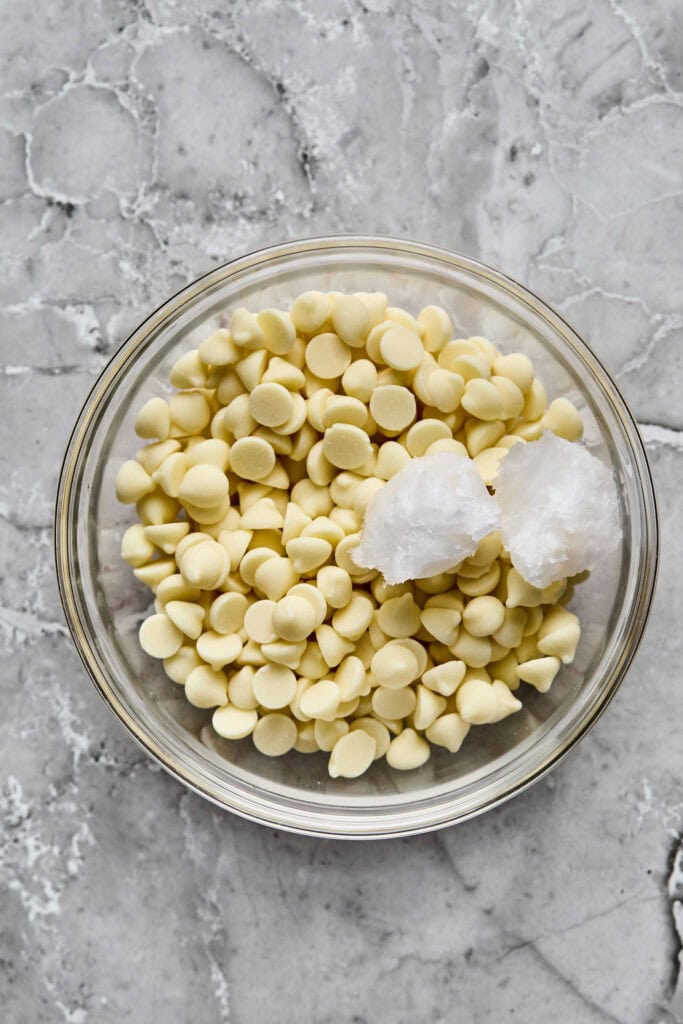 White chocolate chips and coconut oil in a bowl.