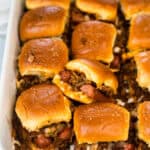 Zoomed in view of Chili Cheese Dog Sliders in a baking dish.