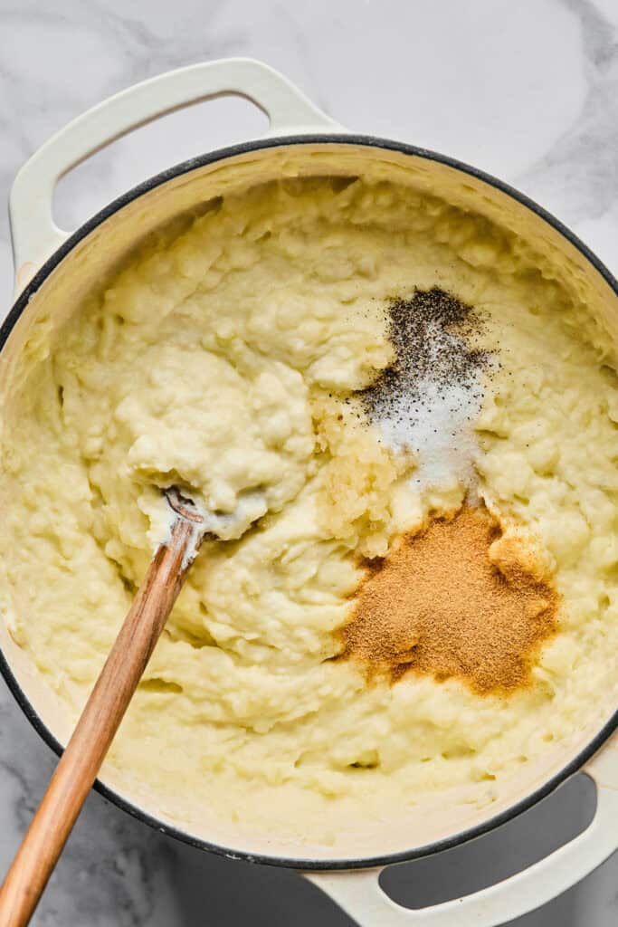 Seasonings being added to the mashed potatoes.