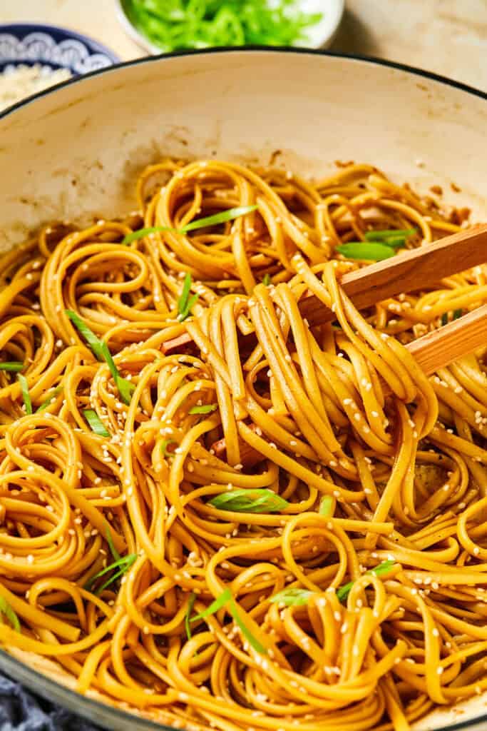Hibachi Noodles in a pot with tongs.