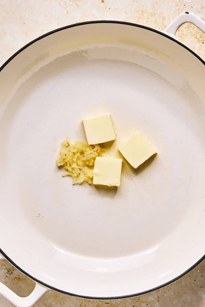 Butter and garlic in a pot.