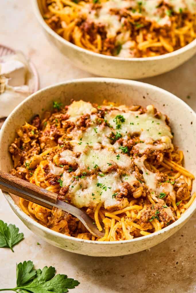 Million Dollar Spaghetti Casserole in bowls eith forks.