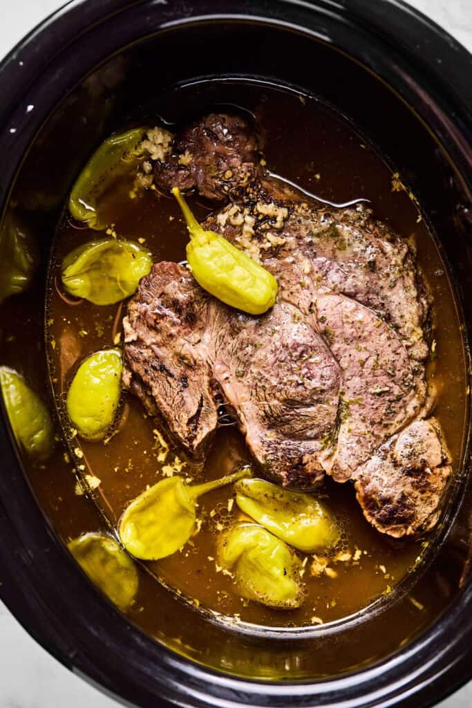 Mississippi Pot Roast in a slow cooker before the meat is shredded.