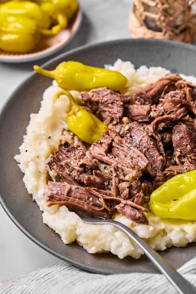 Mississippi Pot Roast with mashed potatoes on a plate.