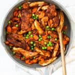Honey Ginger Carrot and Chicken Stir Fry in a pot with a wooden spoon.