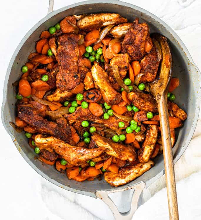Honey Ginger Carrot and Chicken Stir Fry in a pot with a wooden spoon.