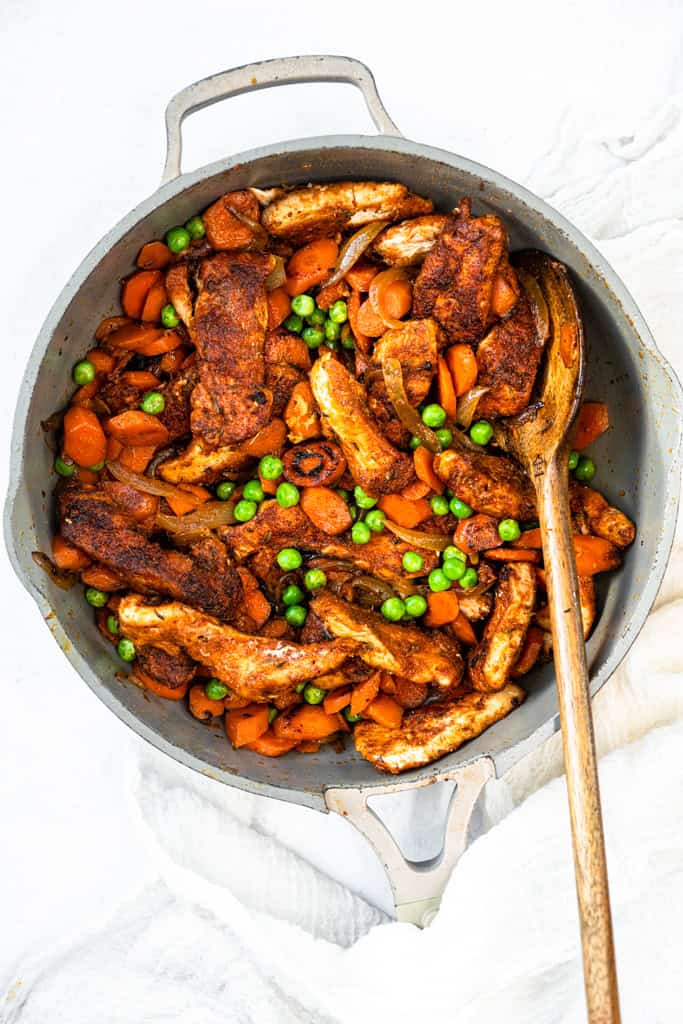 Honey Ginger Carrot and Chicken Stir Fry in a pot with a wooden spoon.