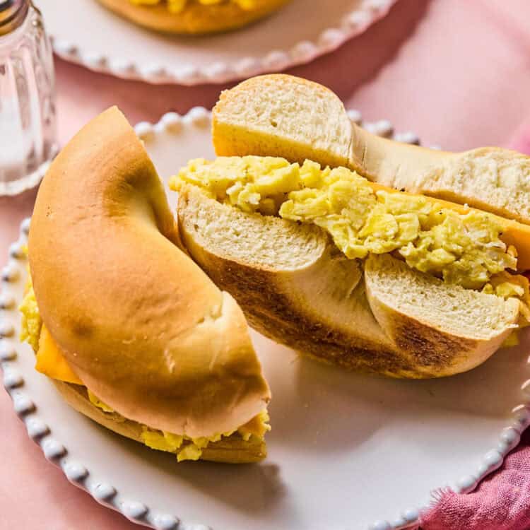 Bagel Breakfast sandwich cut in half on a small plate.