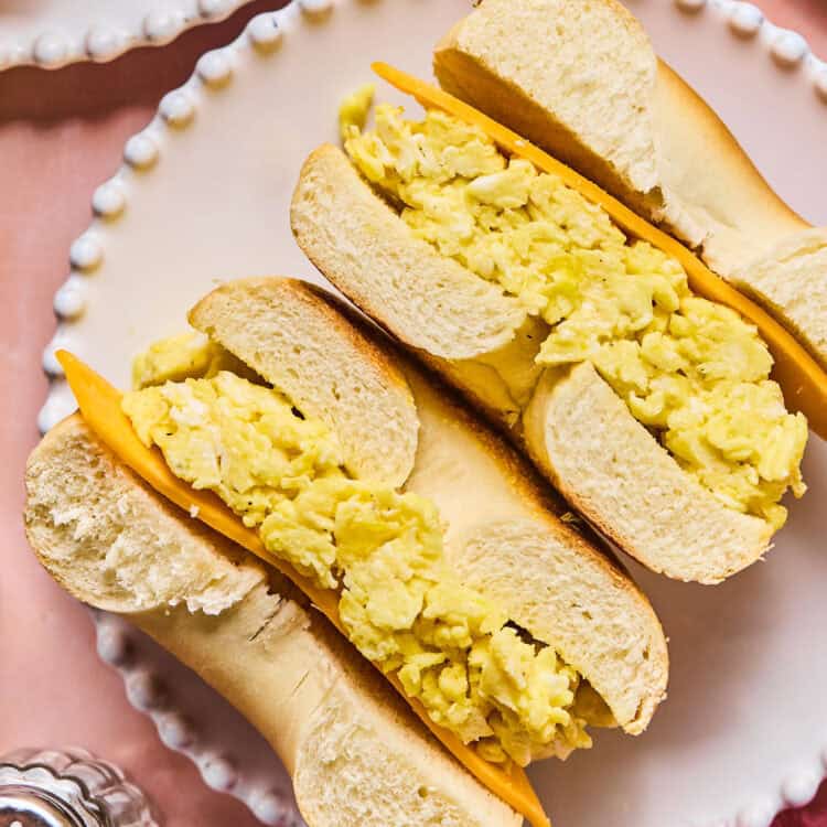 Bagel Breakfast sandwich cut in half on a plate.
