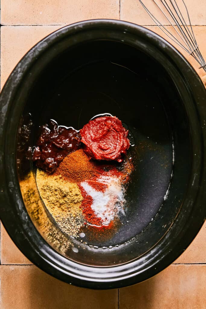 Ingredients for Honey Chipotle Chicken in a slow cooker bowl.
