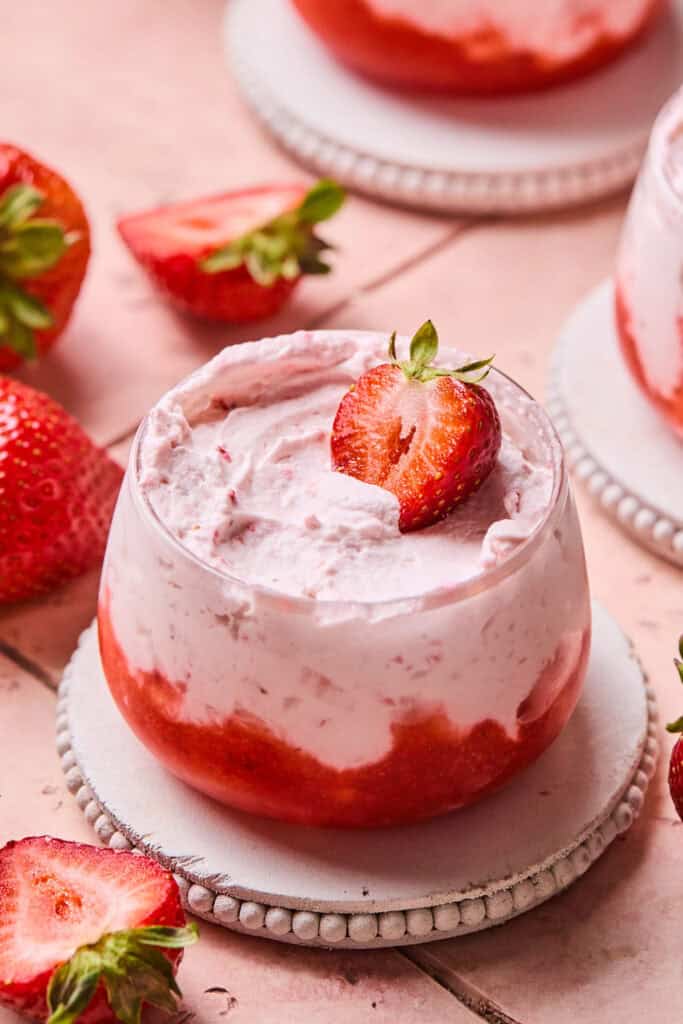 Strawberry Mousse Parfait topped with a strawberry in a small bowl.