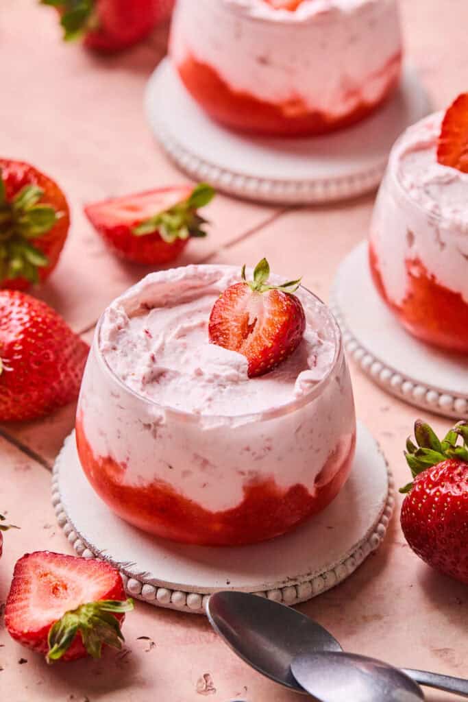 Strawberry Mousse Parfait topped with a strawberry in a small bowl.