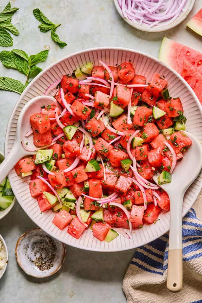 Ingredients for Watermelon Mint Salad mixed otgether in a large bowl.