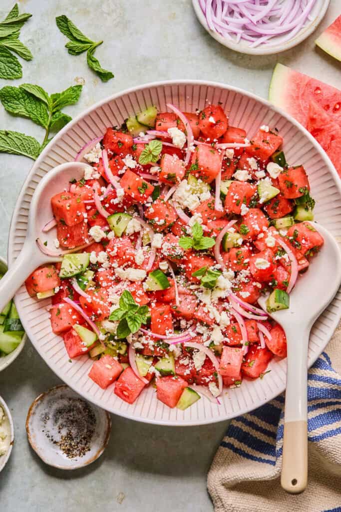 Watermelon Mint Salad in a bowl with a wooden spoon.