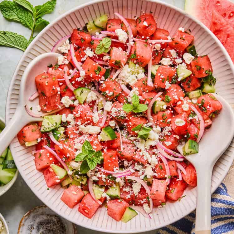 Watermelon Mint Salad in a bowl with a wooden spoon.