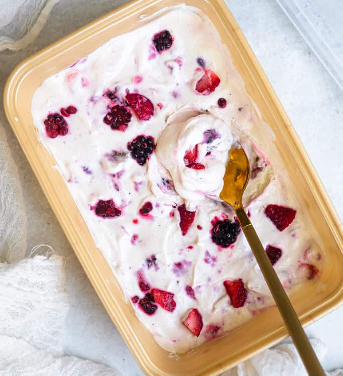 Berry fluff dessert in a rectangular dish with a serving spoon.