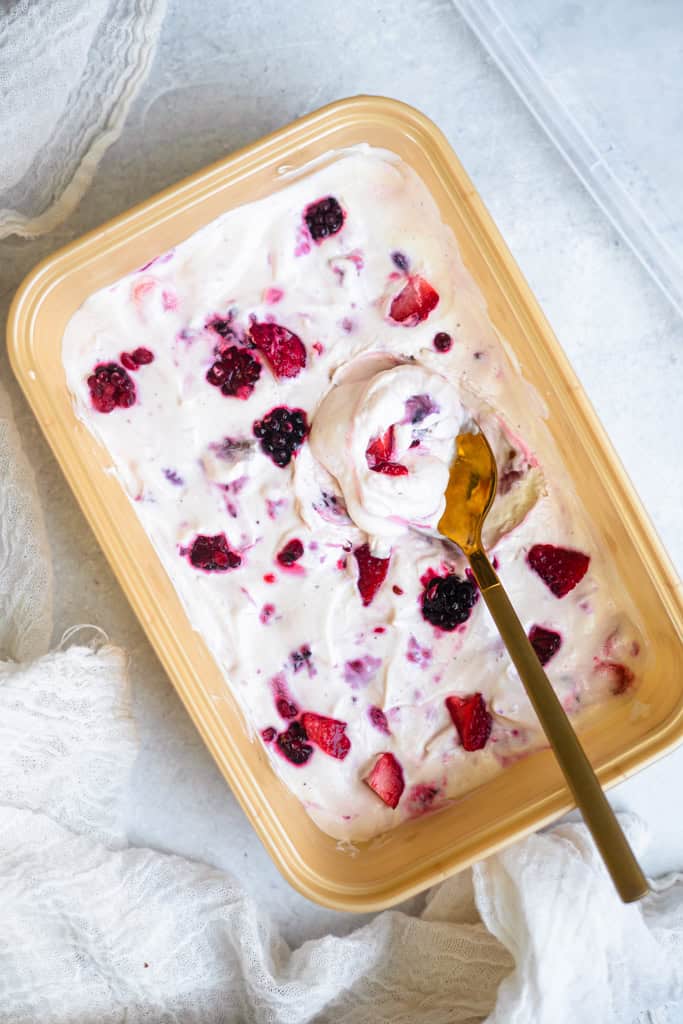 Berry fluff dessert in a rectangular dish with a serving spoon.