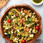 Chicken pesto pasta salad in a serving bowl.