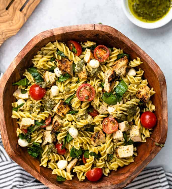 Chicken pesto pasta salad in a serving bowl.