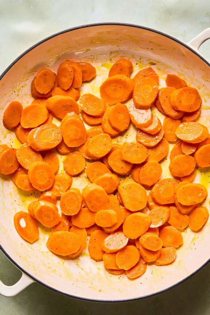 Sliced carrots in a skillet.