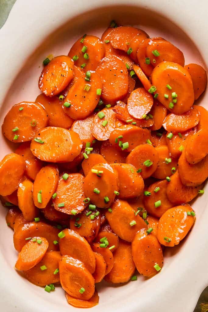 Zoomd in view of Honey Glazed Carrots in an oval serving dish.